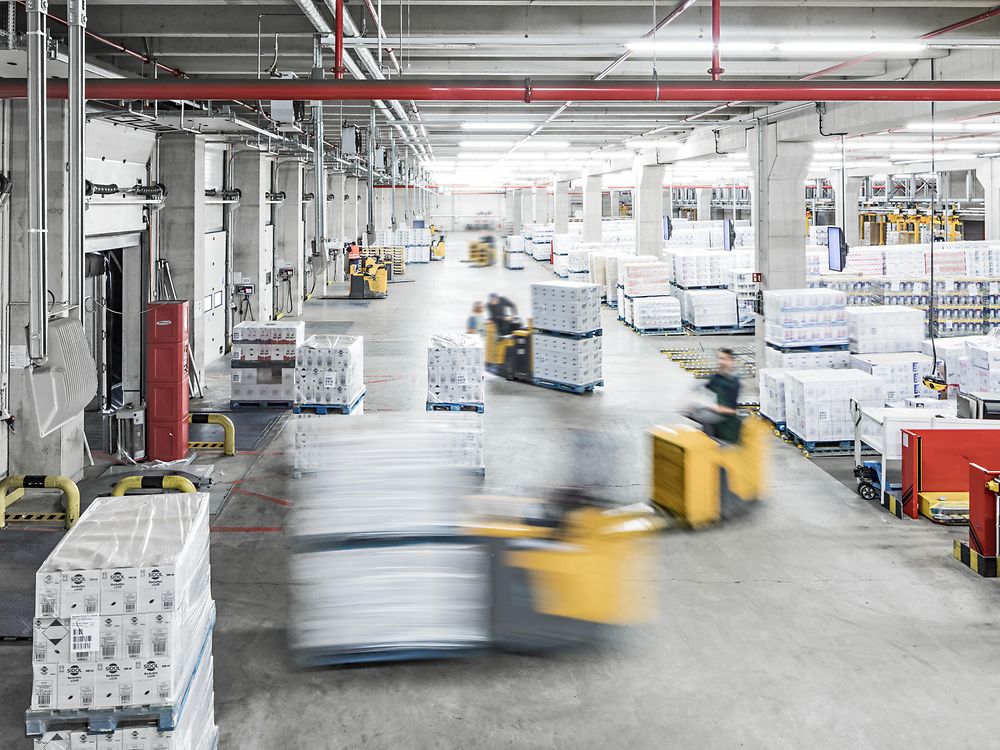 Forklifts carrying packages in production